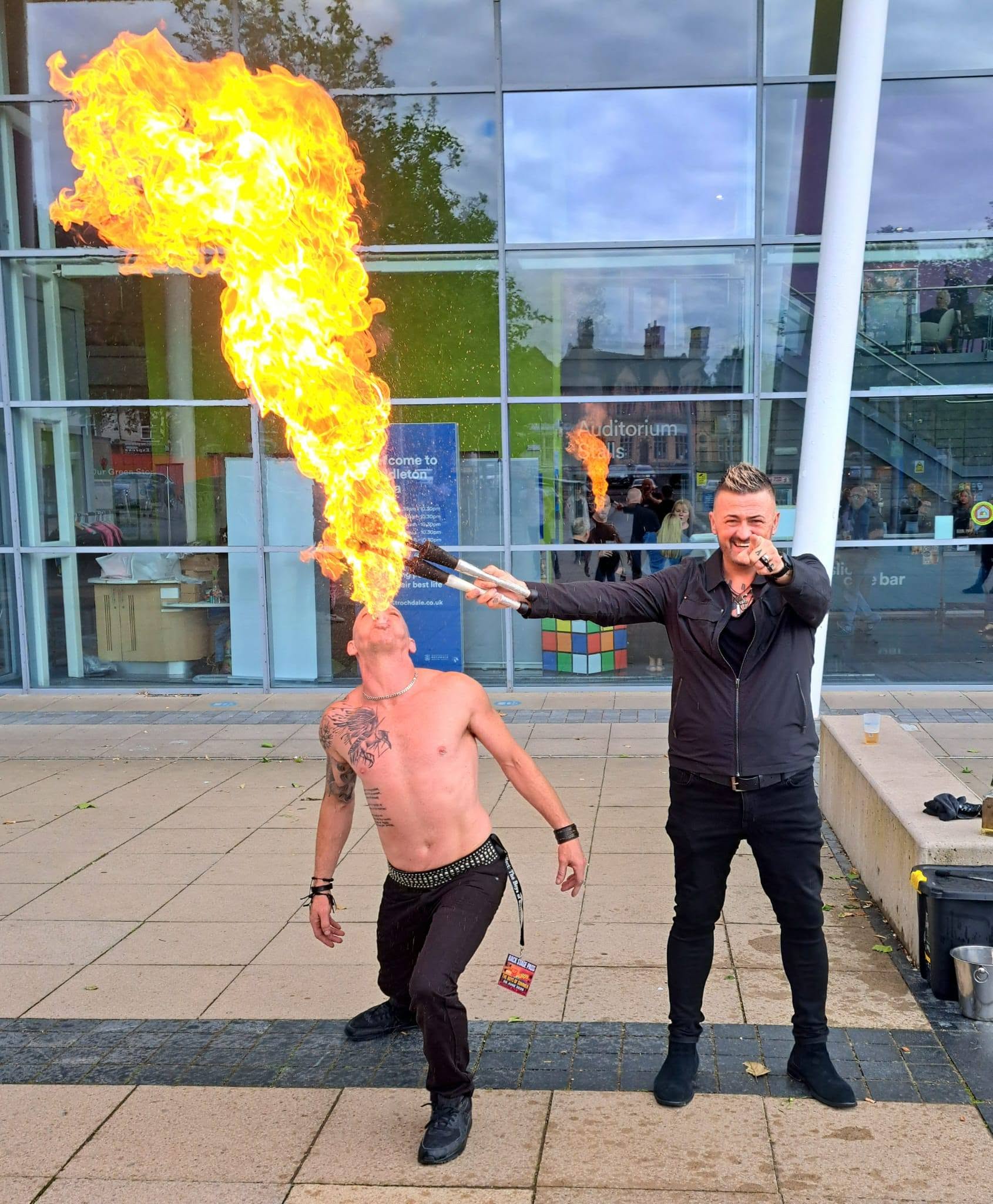 Joey and live fire breather interacting with fans at the front row barrier