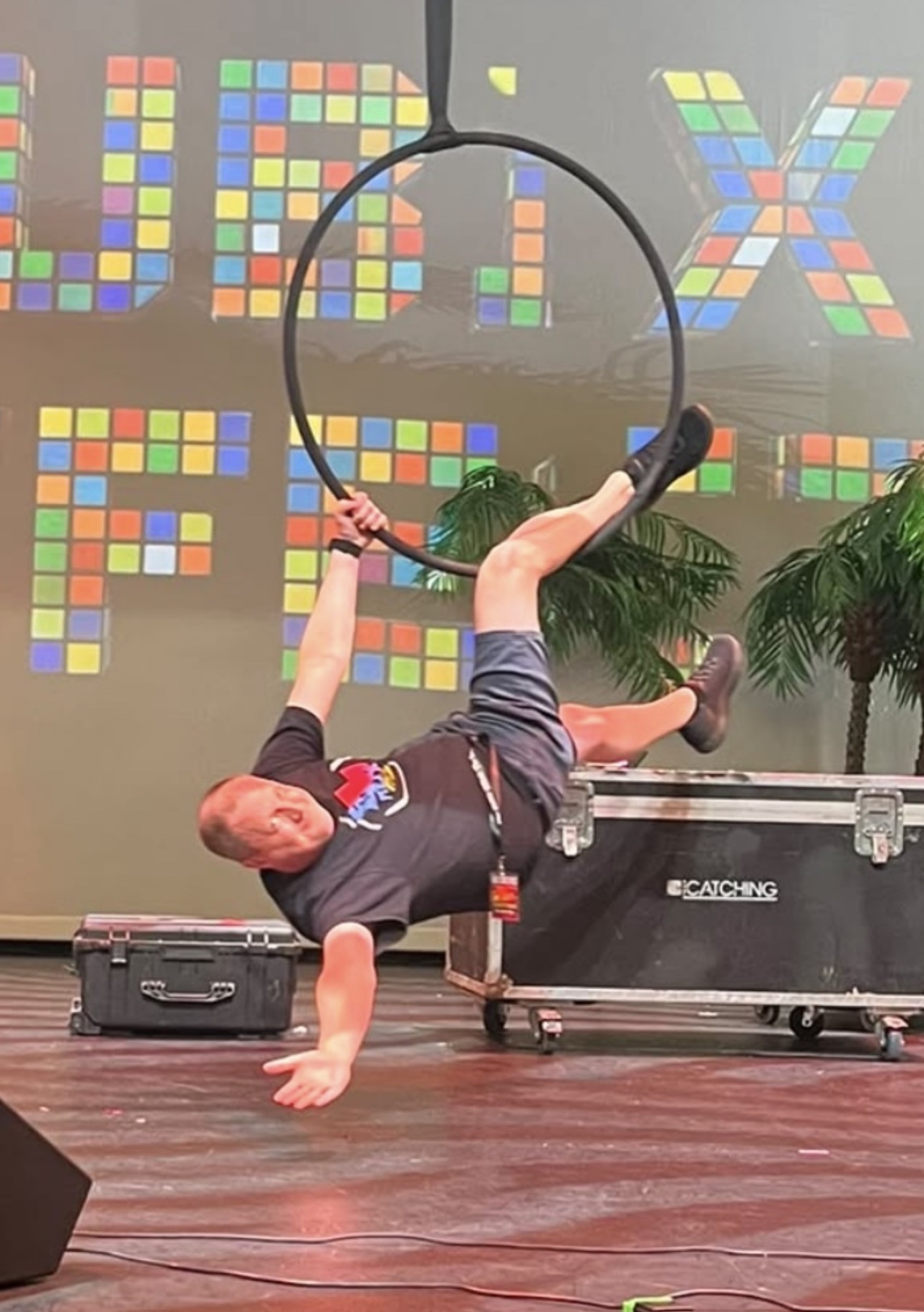 Jordan performing alongside live aerial silk performers on stage